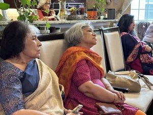 Senior people sitting together and talking in a living room