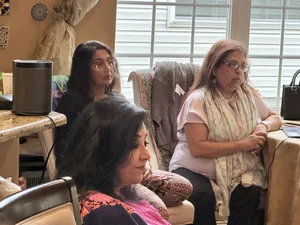 Group discussion between elderly people in a community room