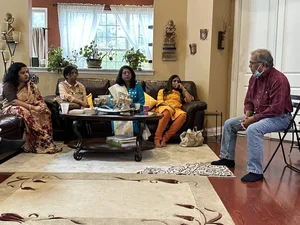 Man sitting in a chair and speaking during a group activity