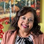 Portrait of a woman with long hair smiling softly